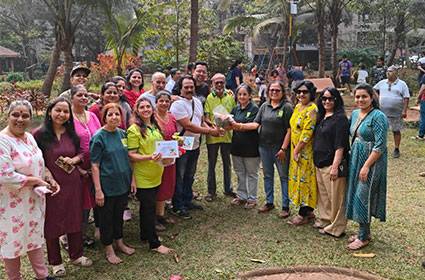 Participants planting young trees during an environmental awareness campaign